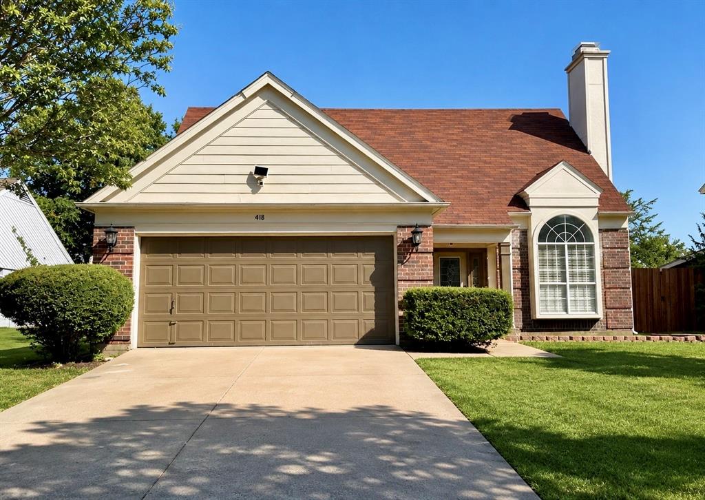 Brick and siding exterior with an attached garage, arched window, and a prominent chimney