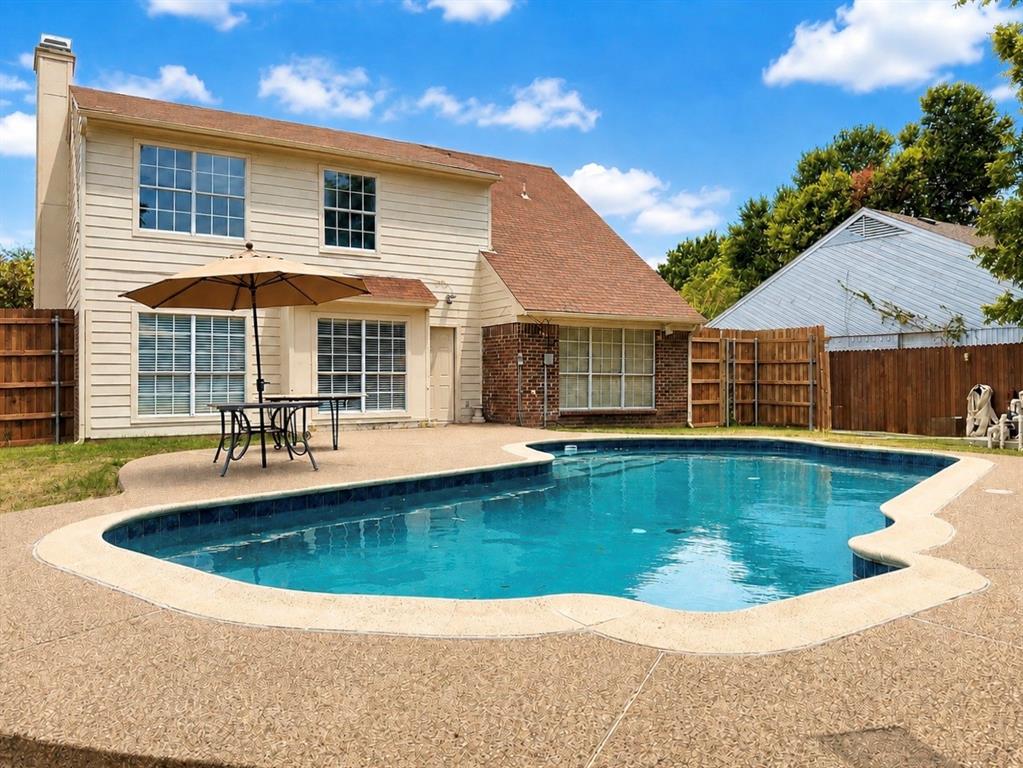 In-ground swimming pool with a surrounding textured concrete deck
