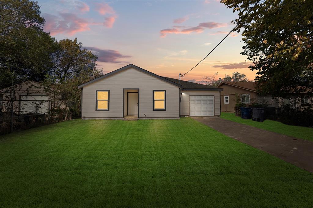 Single-story exterior featuring horizontal siding, an attached garage, and a concrete driveway