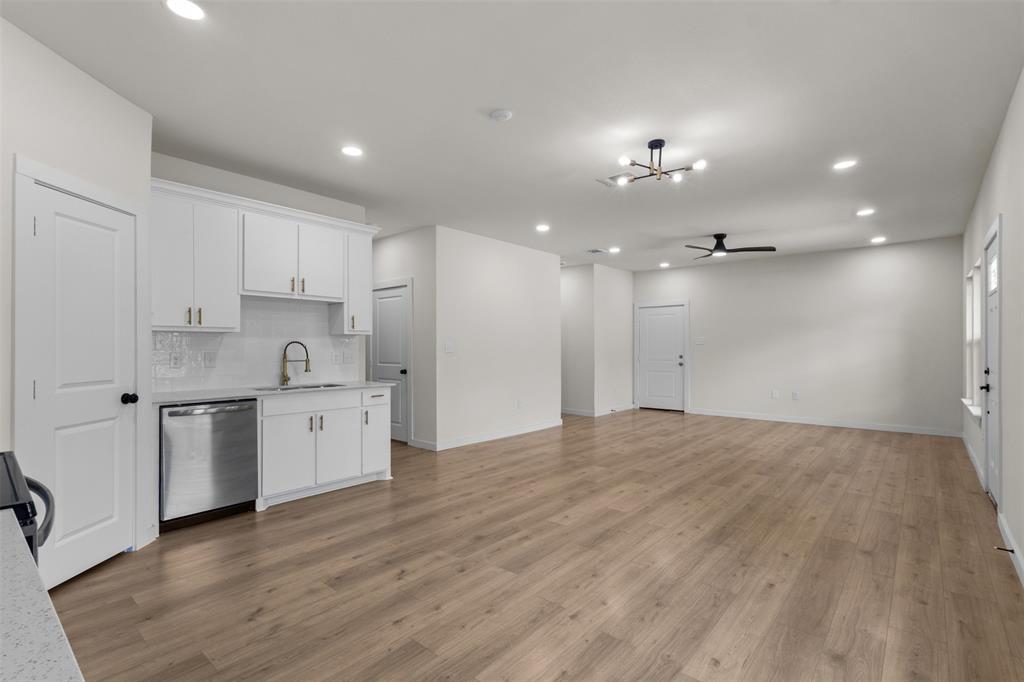 Open-concept living space with wood-finish flooring, recessed lighting, and a modern ceiling fan