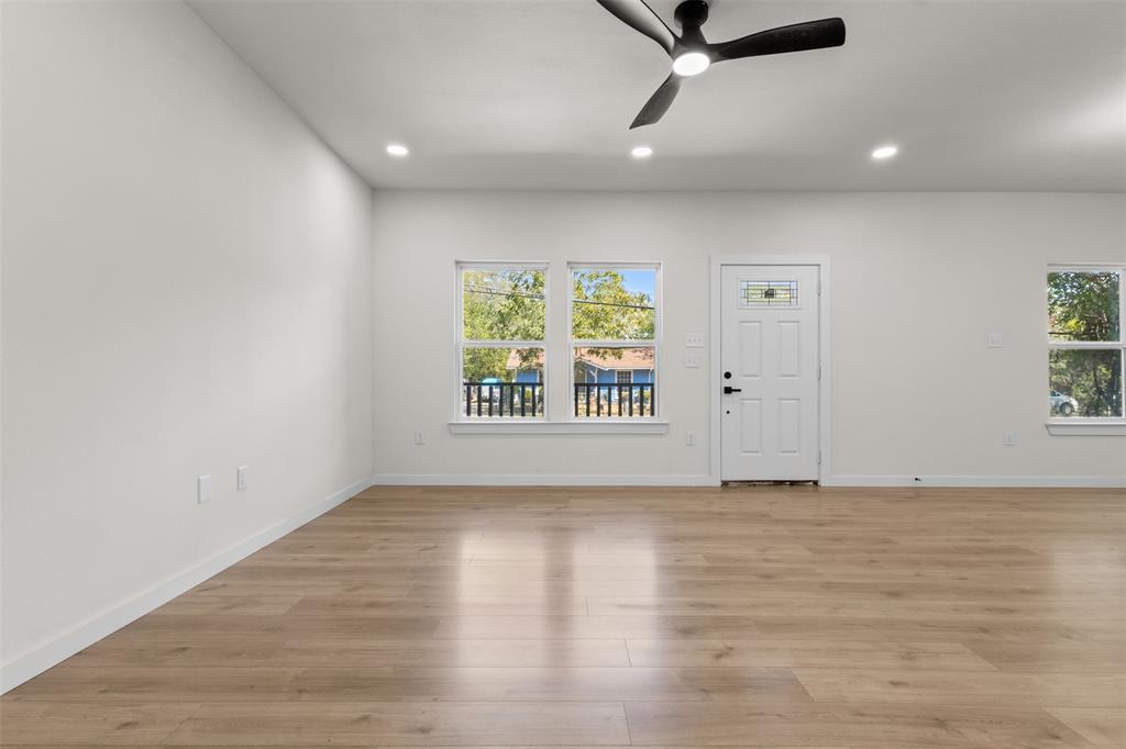 Wood-finish flooring throughout, recessed lighting, and a ceiling fan Wood-finish flooring throughout, recessed lighting, and a ceiling fan
