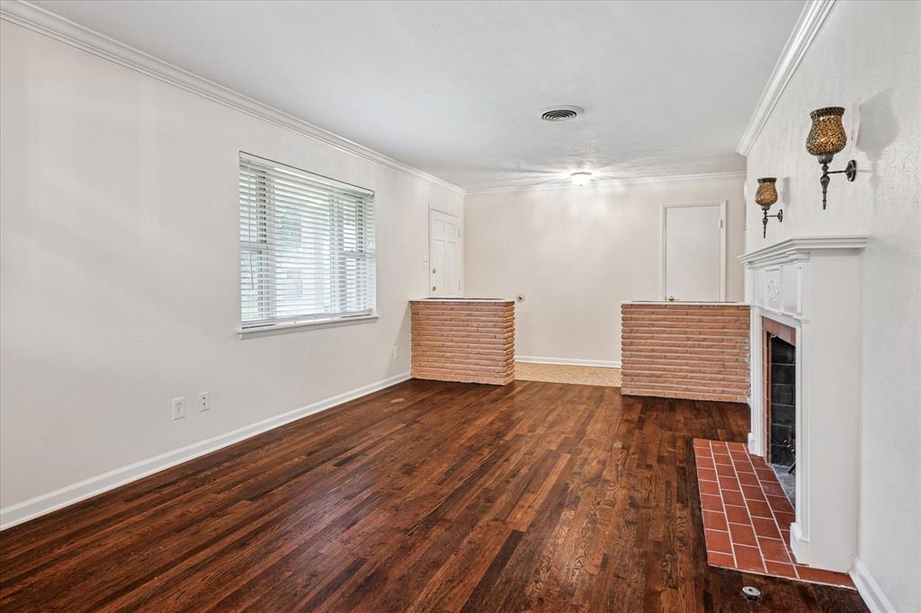 Open formals with original oak hardwoods, brick planters, and tiled entry.
