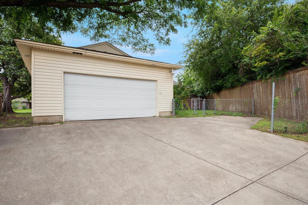 Oversized, attached, rear entry garage with electrical outlets and great storage. Also an additional parking space