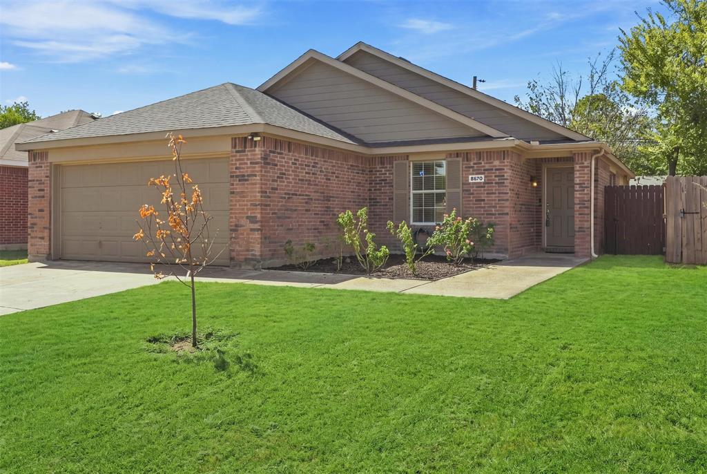 Brick exterior with a single-car garage and a concrete driveway Brick exterior with a single-car garage and a concrete driveway