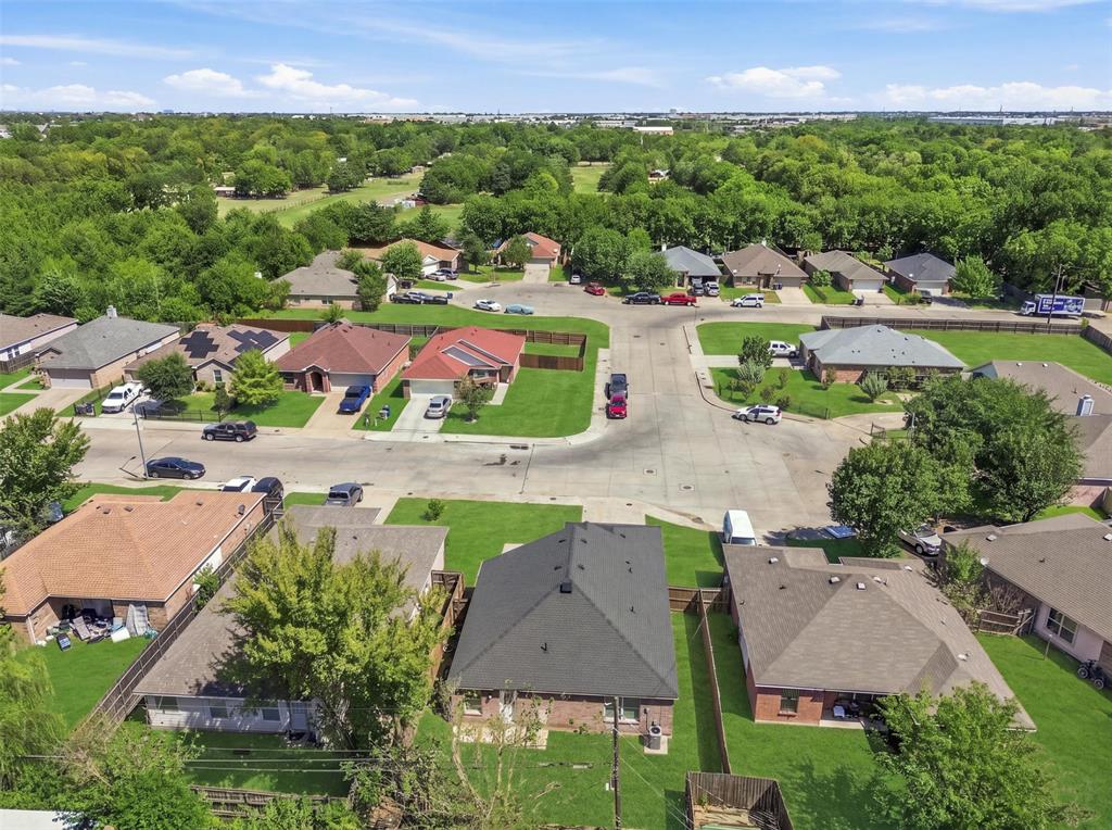 Residential neighborhood with established homes, green spaces, and mature trees