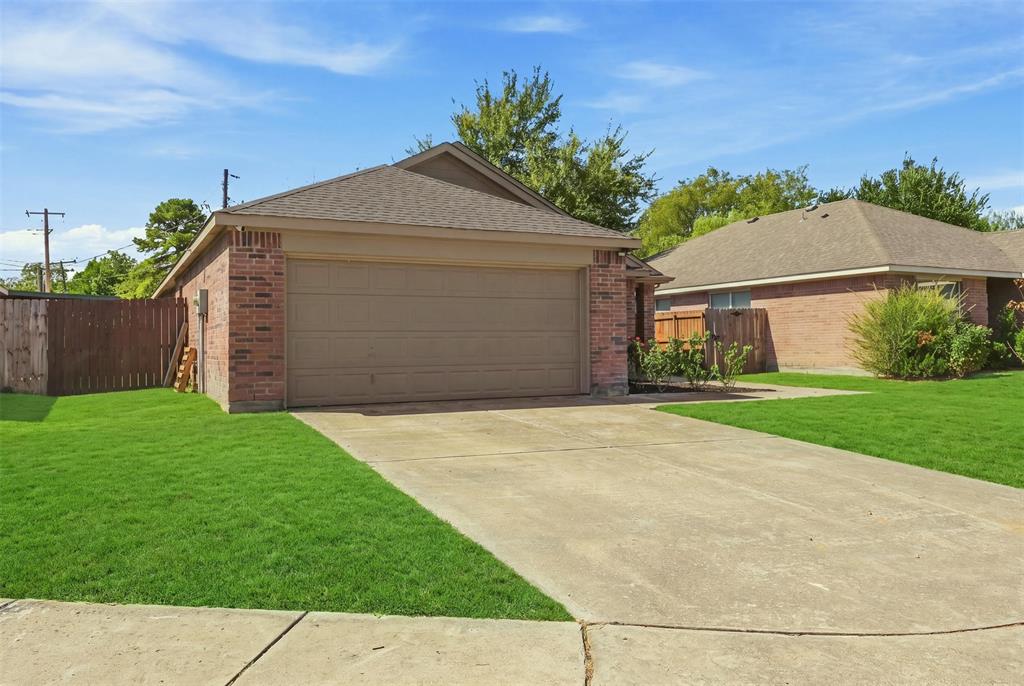 Brick exterior, attached garage, concrete driveway, wood privacy fence, and established landscaping Brick exterior, attached garage, concrete driveway, wood privacy fence, and established landscaping