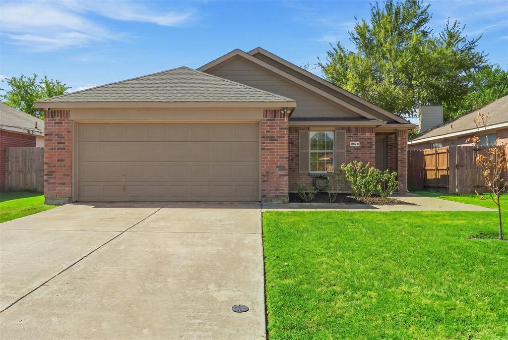 Red brick exterior with a two-car garage, concrete driveway, and front lawn Red brick exterior with a two-car garage, concrete driveway, and front lawn