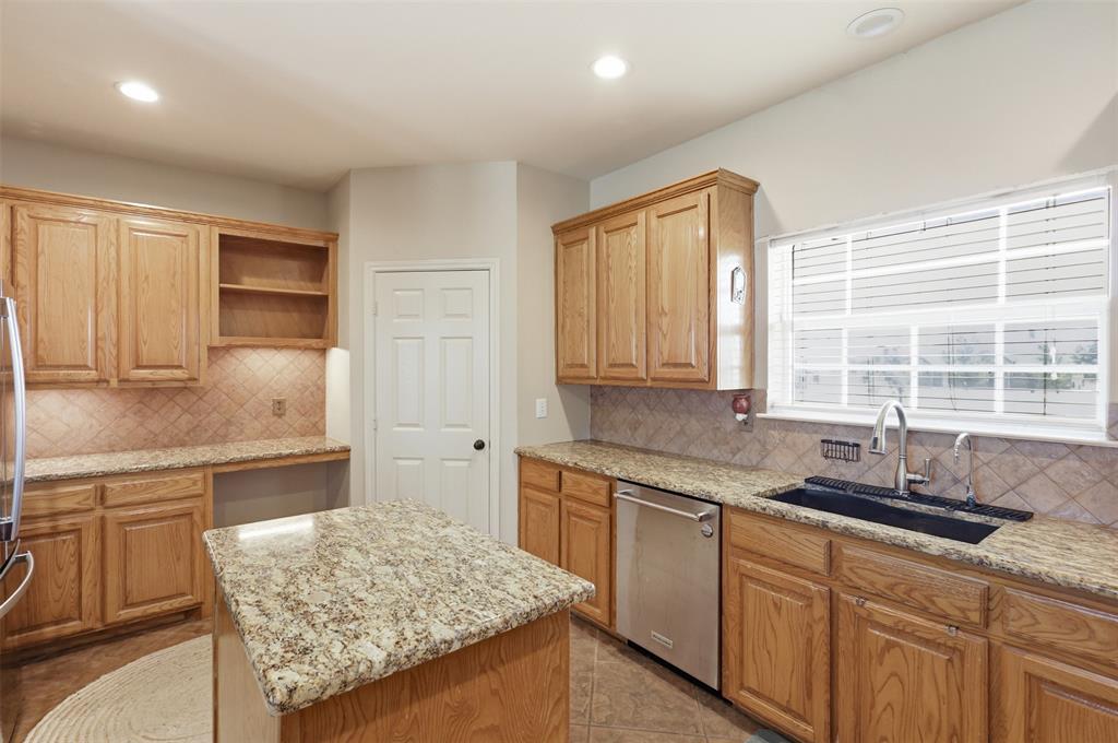 Large window above sink overlooks the front yard.