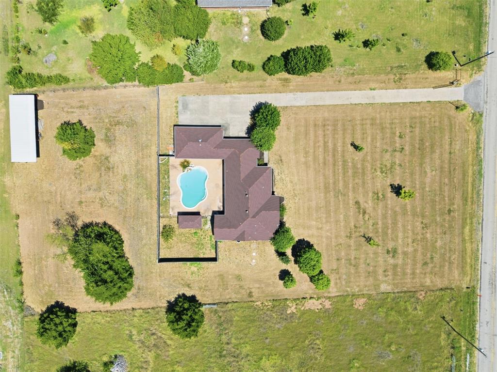 Aerial View detailing the pool and stable.
