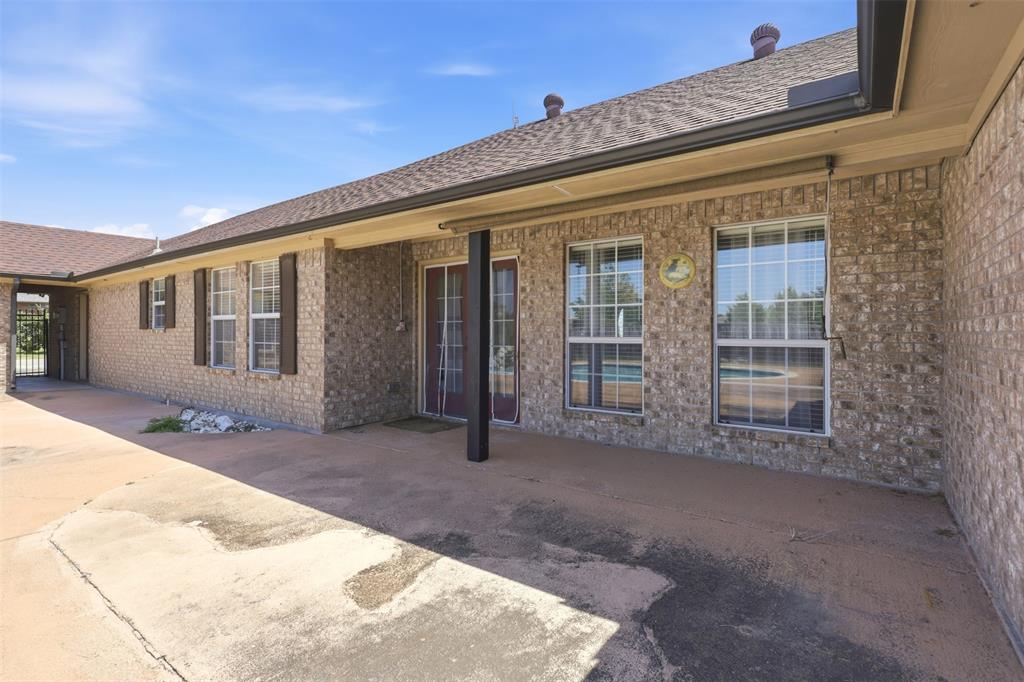 Large covered patio has a gate and access to 3-car garage.