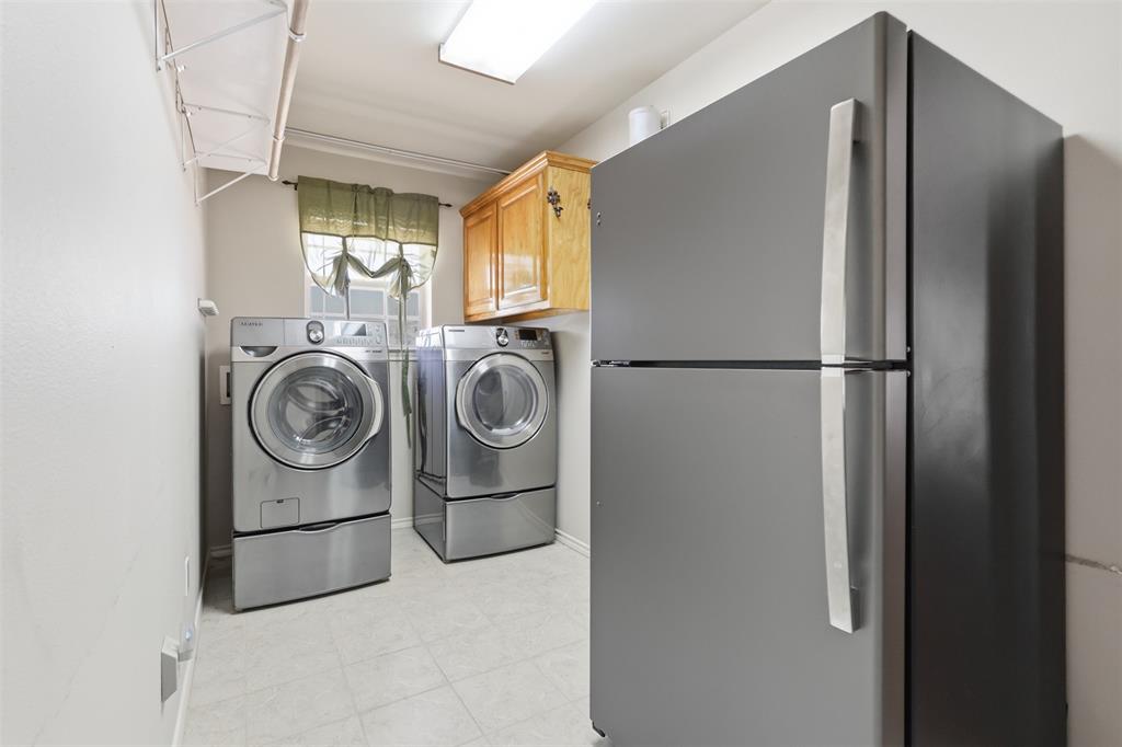 Large utility room allows for second fridge.