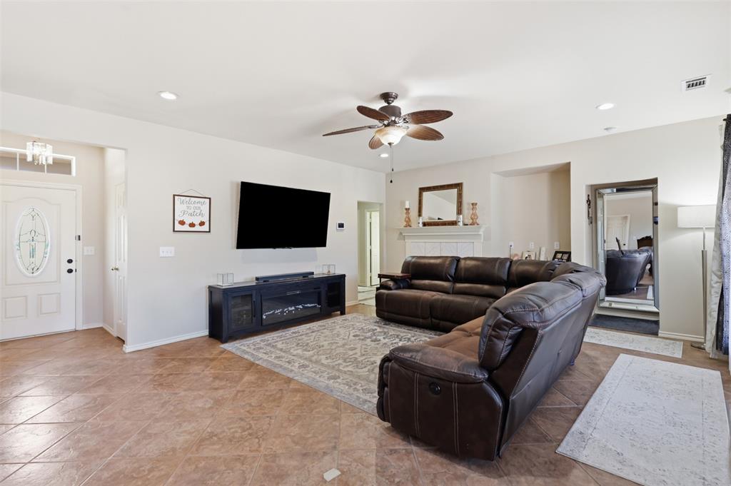 Living room has tile floors for easy clean up and plenty of room for oversized couch.
