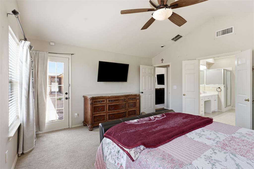Primary bedroom has access to the covered patio and pool area.