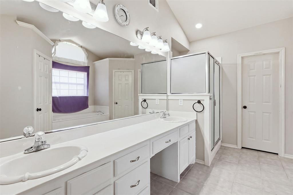 Primary bathroom has double sinks, separate shower and large soaking tub.