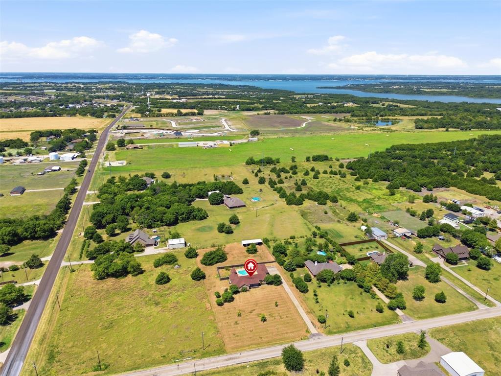 Aerial View shows the property that extends from the driveway to the main road pictured.