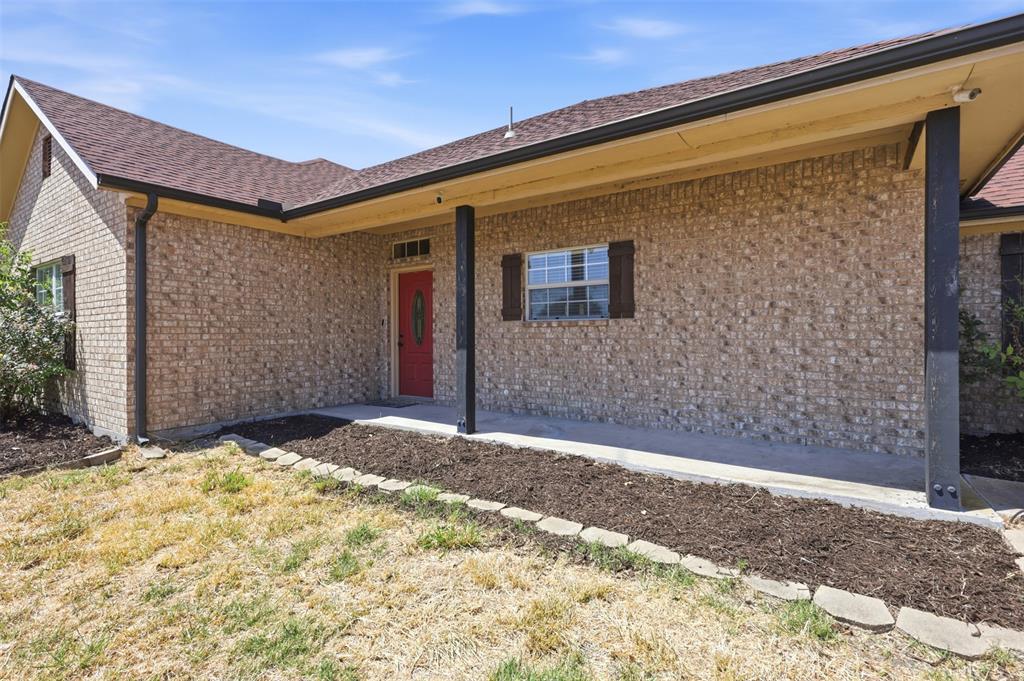 Large covered front porch and defined flower beds welcome you home!