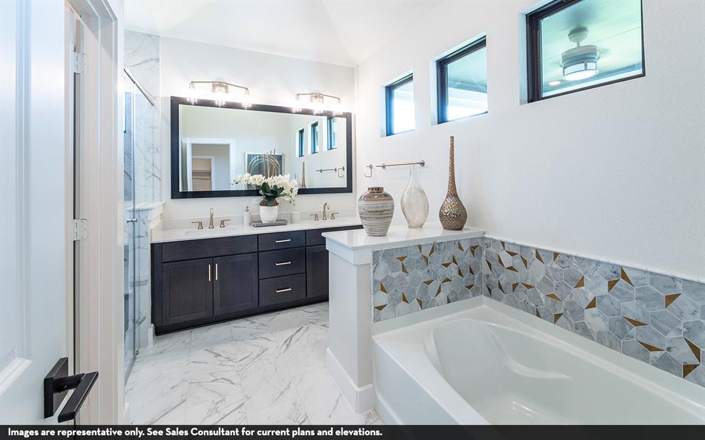 Dual vanity with dark wood-finish cabinetry, white countertops, and a large framed mirror