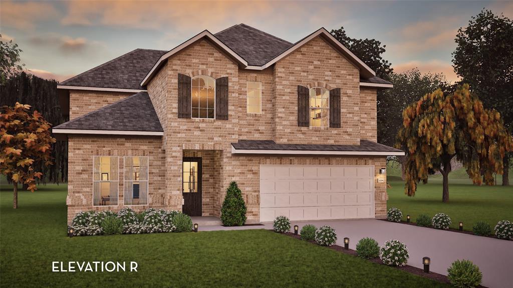 Brick exterior, arched window with shutters, two-car garage, established landscaping, and a well-maintained lawn