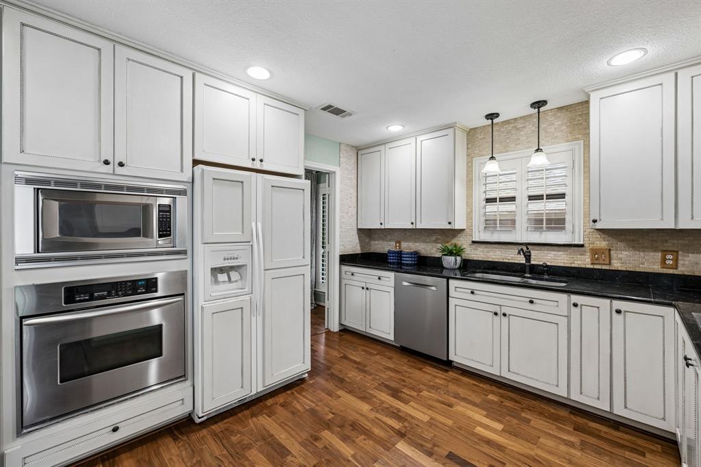 The kitchen features a built-in refrigerator and a recent Bosch dishwasher.