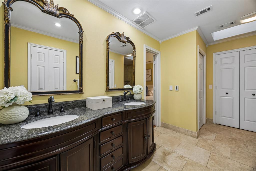 The primary bathroom features a double vanity with storage and the real bonus is the heated floors!