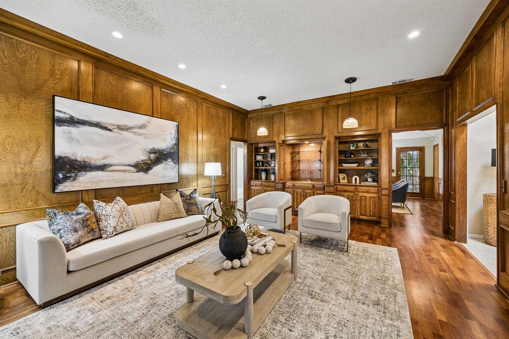 The living room features a wet bar and storage shelves.
