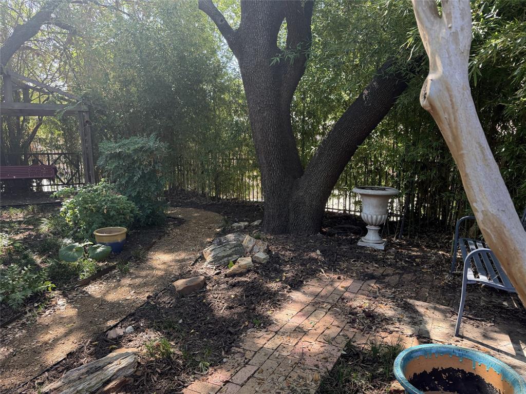 The backyard features mature trees and several garden spots to saunter through and take in the season colors.