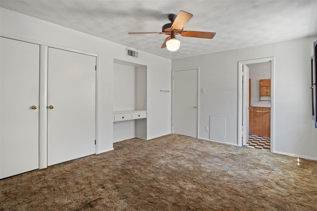 Built-in desk area, dual closets, and ceiling fan with integrated lighting