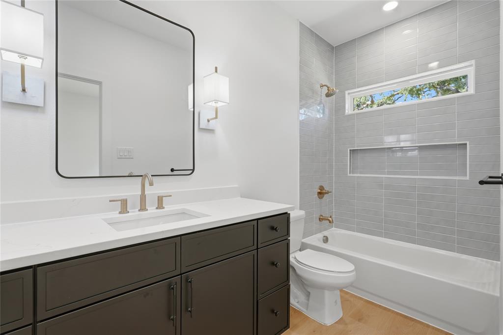 Dark wood-finish vanity with a white countertop and rectangular undermount sink