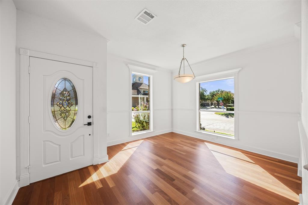 Dining Room with Brazilian Cherry floors installed with custom baseboards and trim