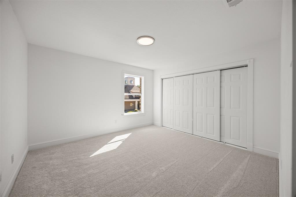 Bedroom 2.  Closet has 9' sliding door system, interior shelving, LED lighting and new Shaw Carpeting and Pad installed.