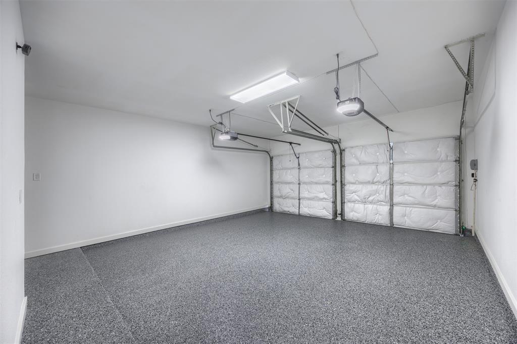 The garage has been totally renovated and updated.  Each garage door is insulated with 3M insulation.  New Chaberlain Premier, quiet belt driven with battery backup, single lens LED camera, My Q Smart Control. Two remotes, exterior openers for mounting are included.  Flooring is 100% Polyurea System, UV Stable, Torginol Chip, Polyaspartic Top Coat.