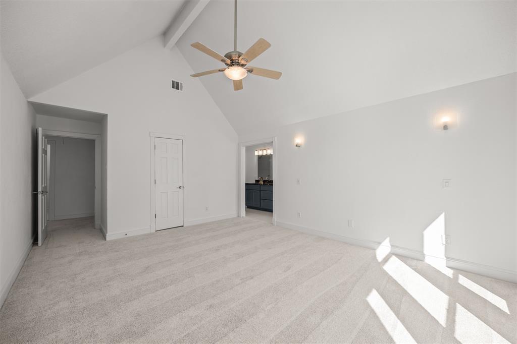 Photograph taken from front bedroom wall looking back toward entry door, walk-in closet door and master bath.  New Shaw carpet/pad installed on stairs and in all bedrooms.
