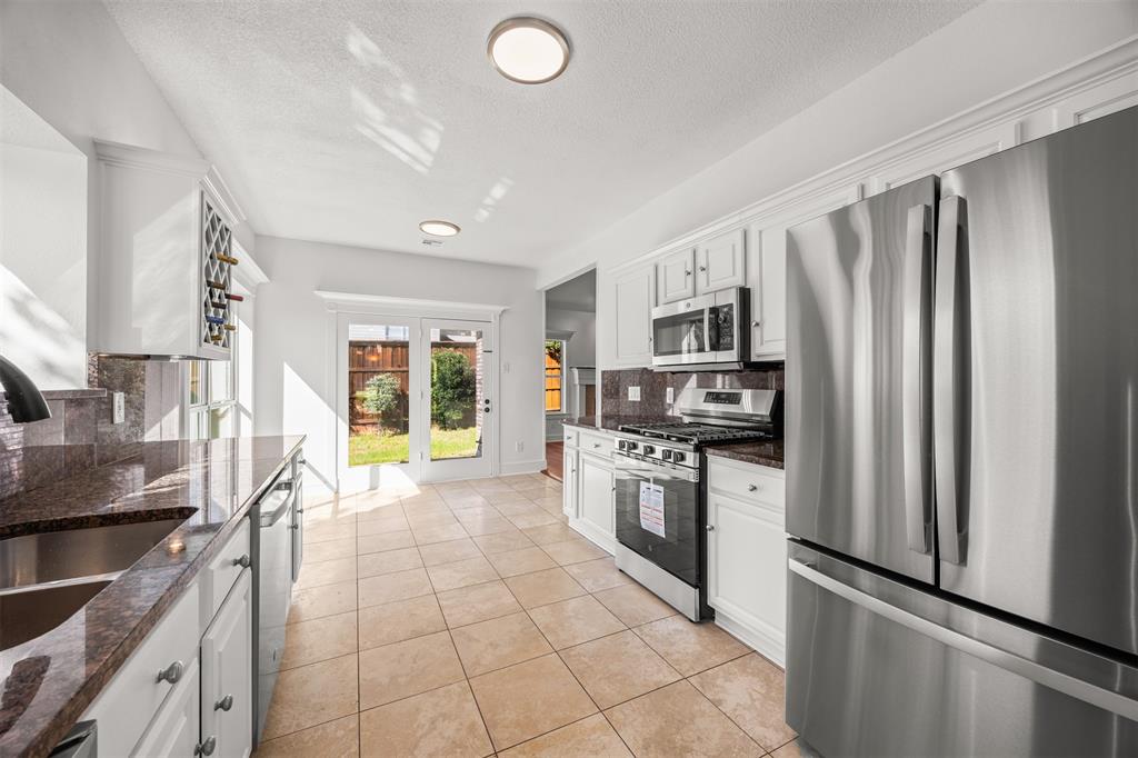 Beautiful granite countertops and backsplash installed with under and over cabinet lighting, wine storage cabinet, soft close hinges on all doors and LED lighting.  Travertine flooring tile is installed throughout the kitchen and breakfast area