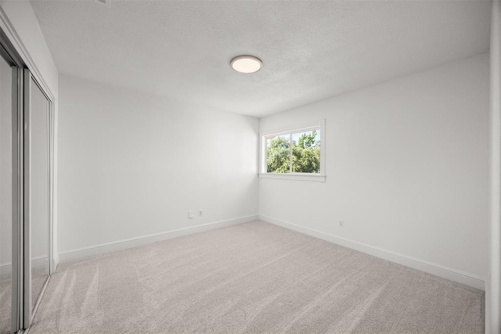Bedroom 3.  Closet has sliding mirrored doors with interior shelving.  New Shaw Carpeting & Pad Installed.  LED Lighting.