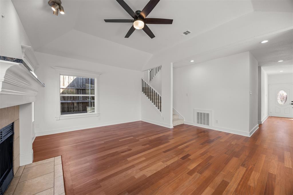 Photograph showing the front door, hallway, living room and stairs to the second floor.  All flooring in these areas are Brazilian Cherry hardwood.  The floors are not engineered, plywood strand oriented board (OSB) or Medium Density Fiberboard (MDF)