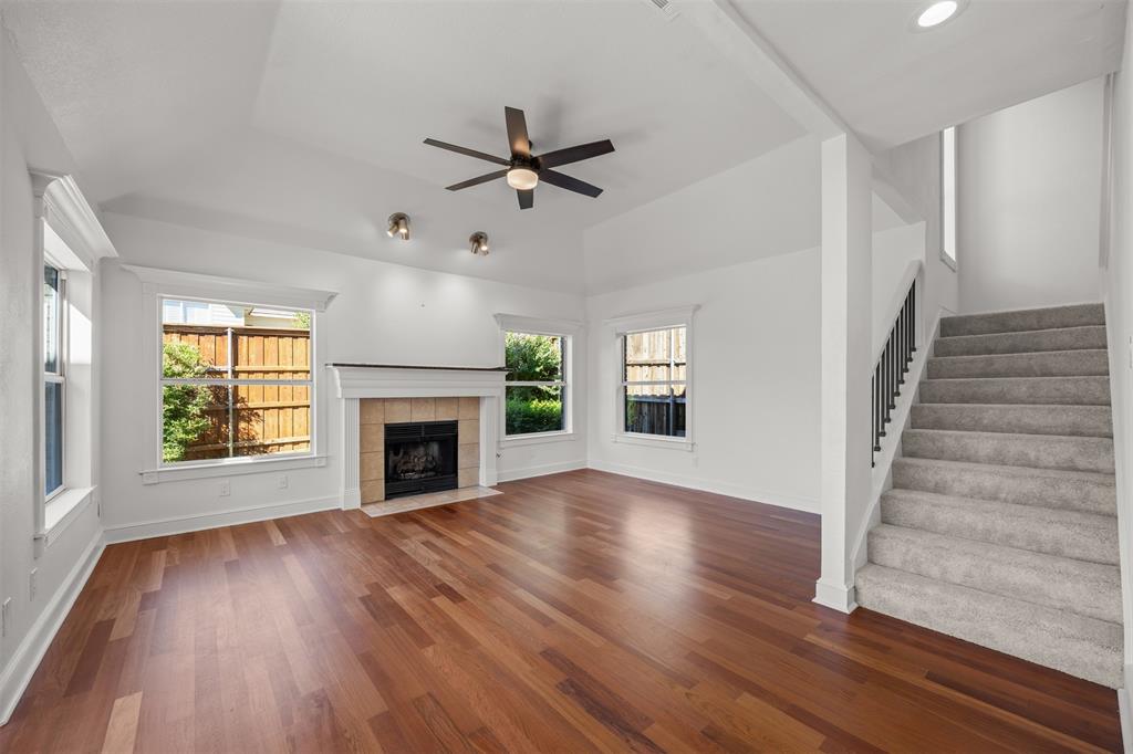 Photgraph taken from entrance hall into the living room showing stairs to 2nd floor on the right.