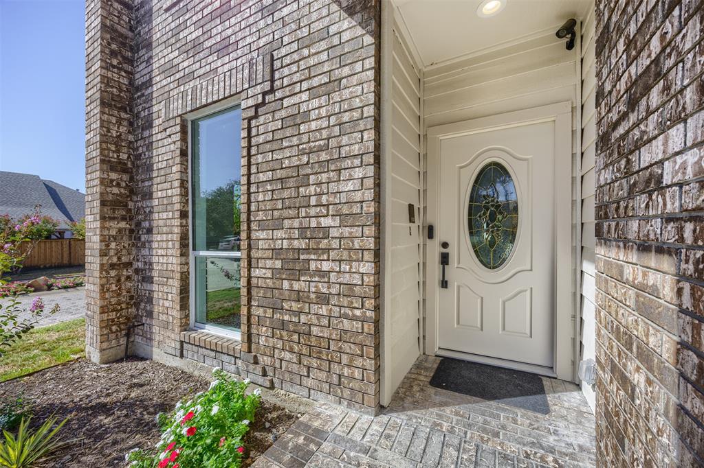 The covered entrance is approximately 6' with LED lighting and solid wood door with beveled glass.