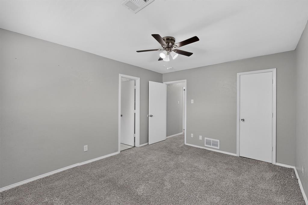 Plush carpet flooring, neutral paint palette, white trim, and a ceiling fan with integrated lighting