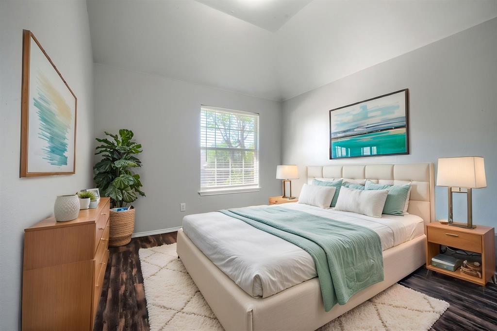 Vaulted ceiling, recessed lighting, wood-finish flooring, and a window with blinds