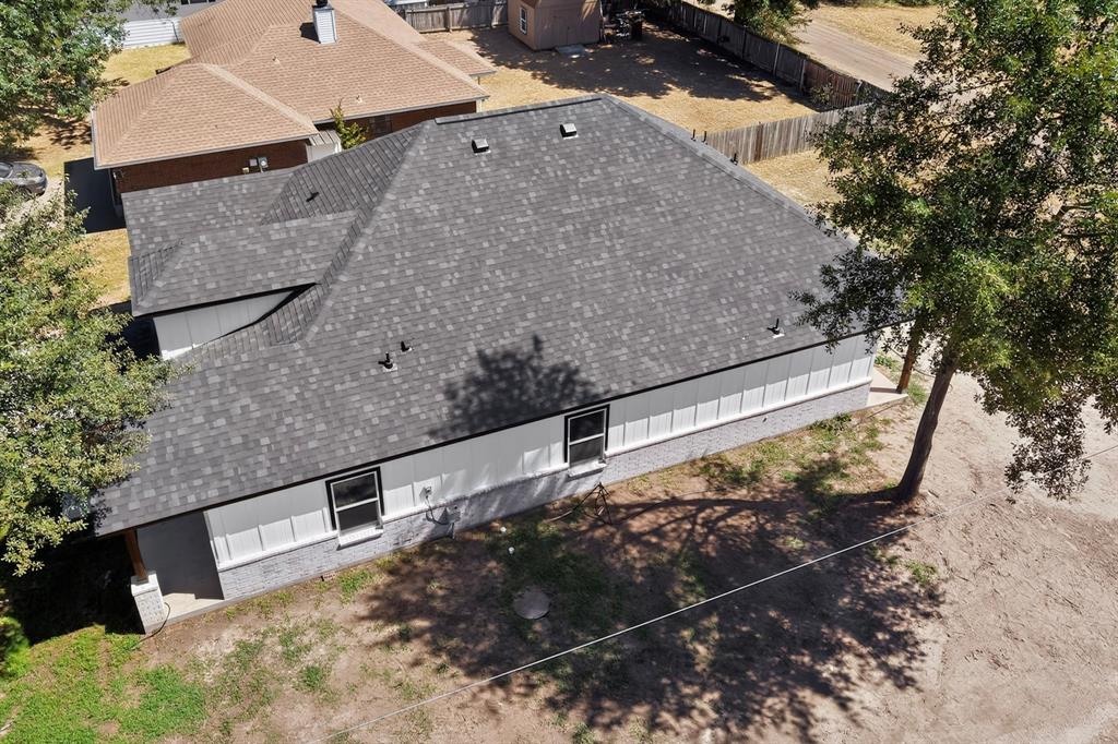 Gray shingle roof, white siding, and gray brick veneer