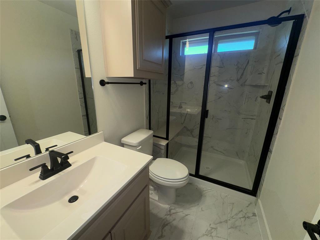 Walk-in shower with black-framed glass enclosure Walk-in shower with black-framed glass enclosure