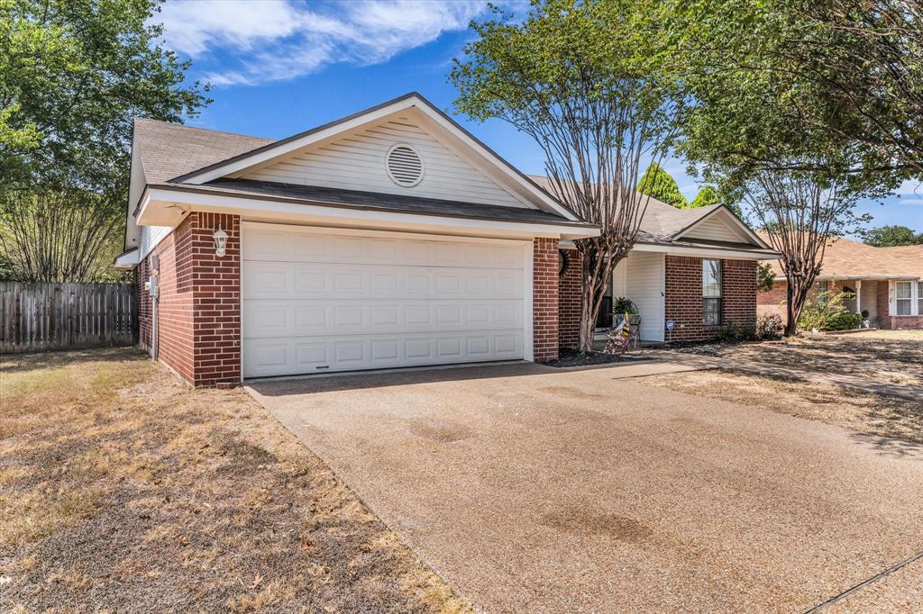 Brick exterior with white siding accents and an attached garage