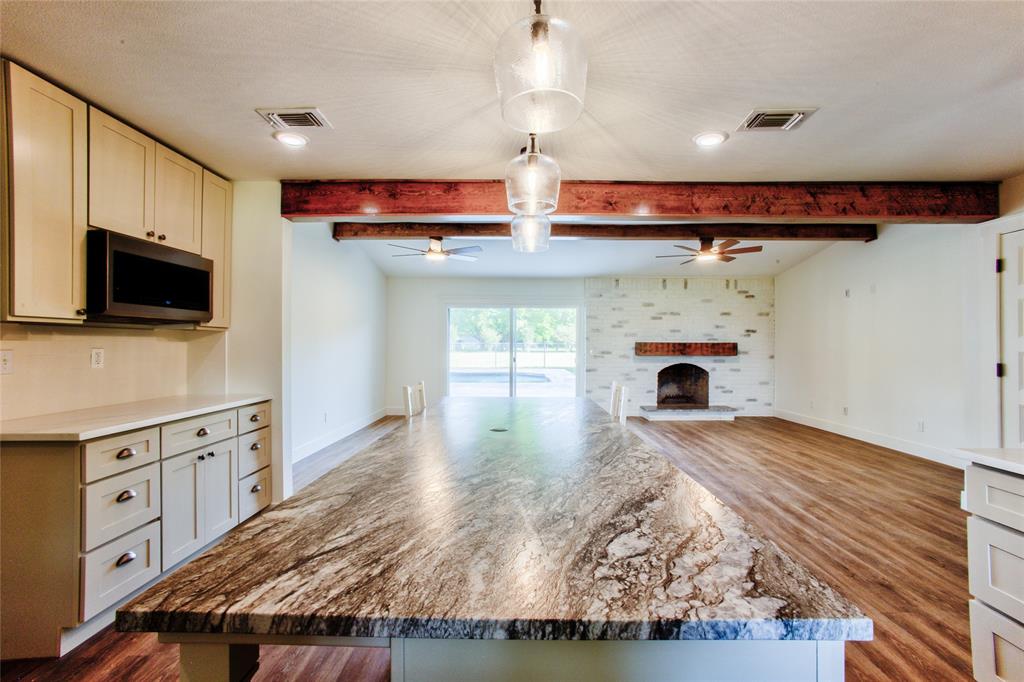 The Longest View across the Kitchen Island through the Gathering Room & Out the Sliding Door/