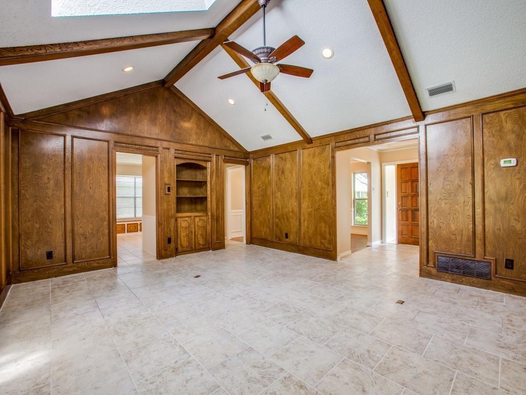 Vaulted ceiling with exposed wood beams, ceiling fan, recessed lighting, wood paneling, and ceramic tile flooring