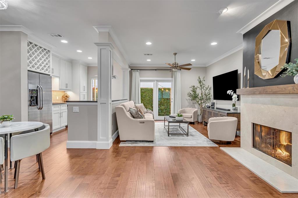 Wood-finish flooring throughout, with a built-in fireplace, recessed lighting, and a ceiling fan