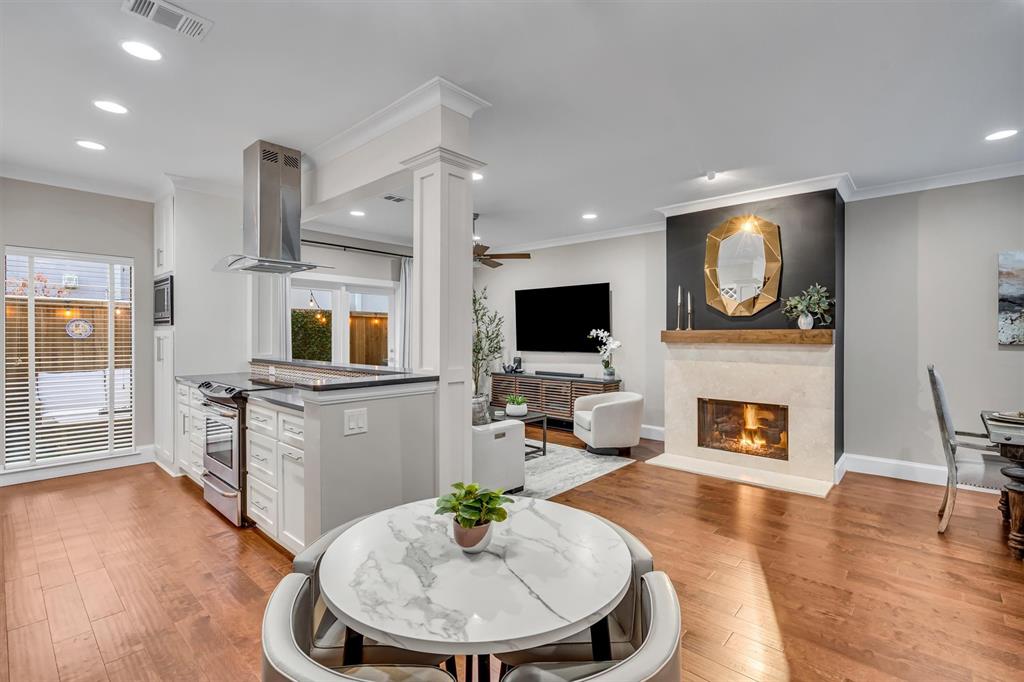 Open floor plan with living, dining, breakfast room/bar, kitchen and bathroom.