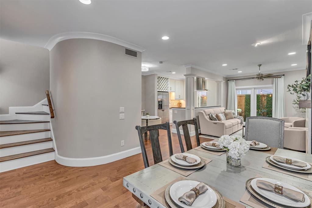 Hardwood-finish flooring throughout, recessed ceiling lighting, crown molding, and a staircase.