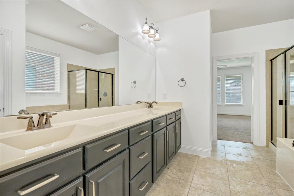 Dual vanity with integrated sinks, dark wood-finish cabinetry, and brushed nickel fixtures