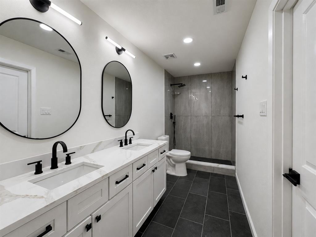Dual vanity with white shaker cabinetry, integrated rectangular sinks, and matte black fixtures