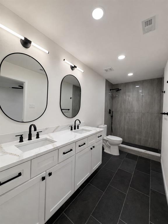 Dual vanity with white shaker-style cabinetry, white countertops, and matte black hardware